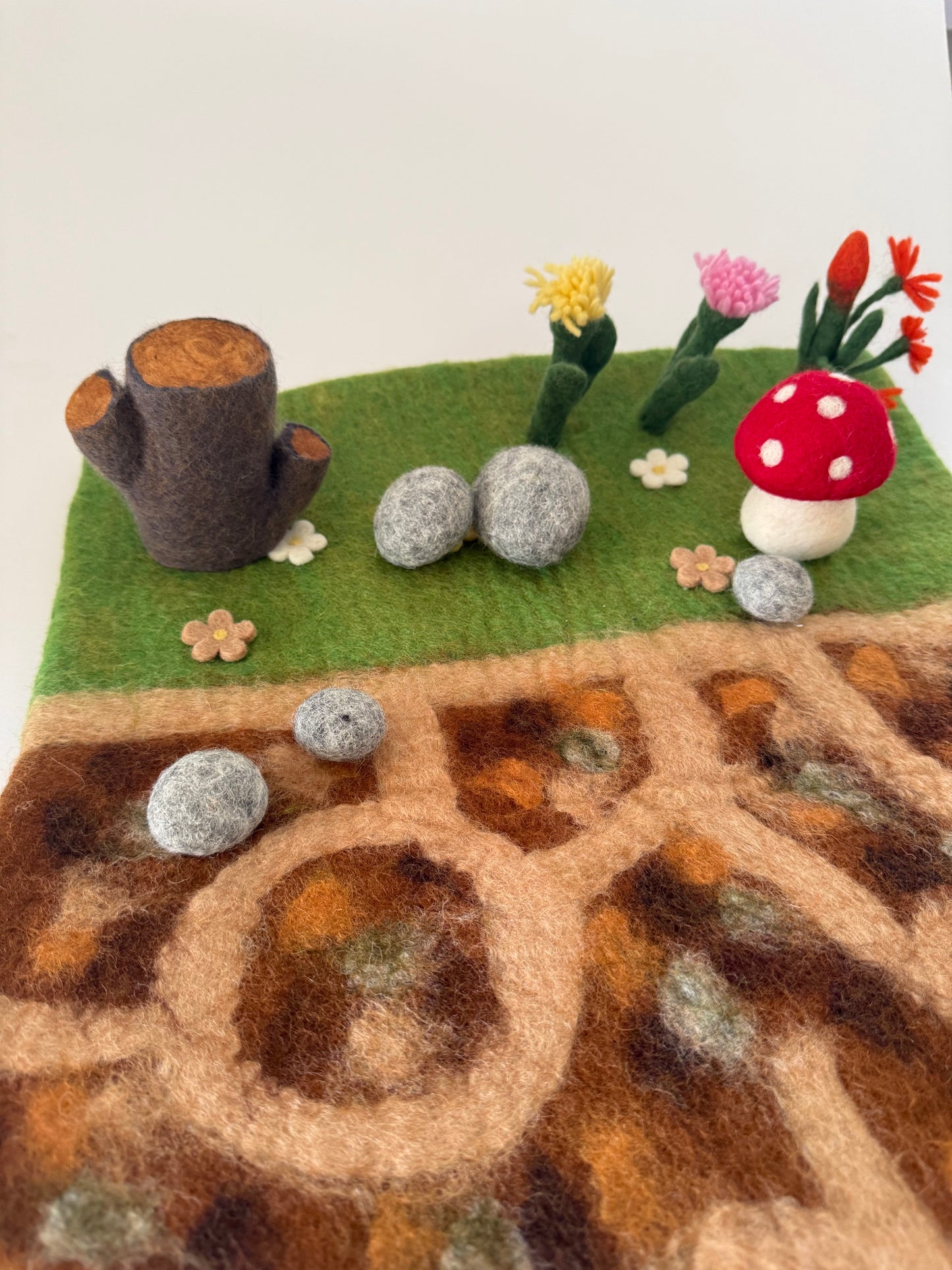 Below the garden felt play mat