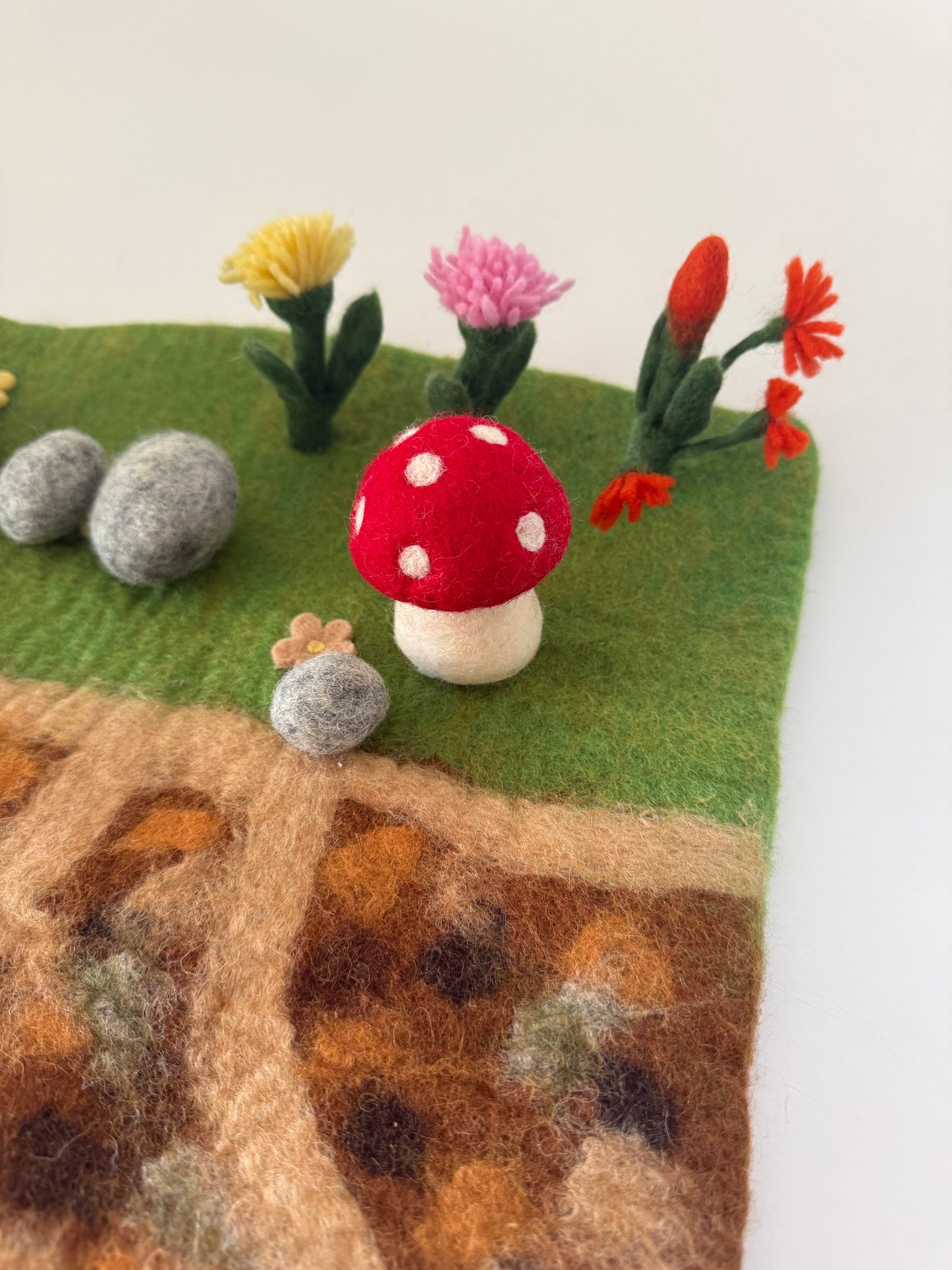 Below the garden felt play mat