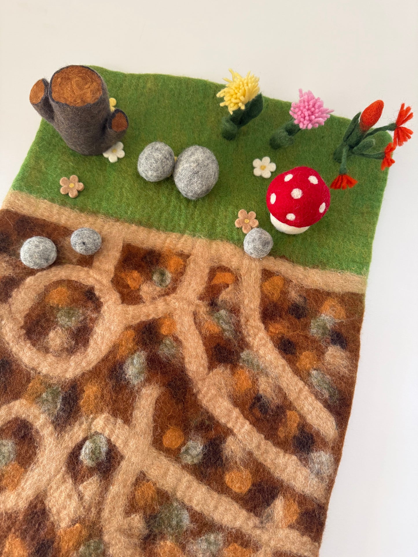 Below the garden felt play mat